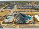 Aerial view of a community clubhouse with pools, sun loungers, and parking spaces at 3020 Mavisbank Cir, Apex, NC 27502