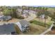 Aerial view of a two-story home in a residential neighborhood with mature trees, and cul-de-sac at 3020 Mavisbank Cir, Apex, NC 27502