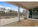 Spacious back deck featuring wood flooring, white railings and sliding glass doors to the interior at 3020 Mavisbank Cir, Apex, NC 27502
