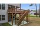 Wooden stairs leading up to a covered back deck, with a concrete patio underneath at 3020 Mavisbank Cir, Apex, NC 27502