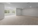 Large basement area featuring neutral carpet, recessed lighting, and bright windows at 3020 Mavisbank Cir, Apex, NC 27502