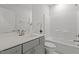 Bathroom featuring gray vanity, quartz countertops, and a shower-tub combo at 3020 Mavisbank Cir, Apex, NC 27502