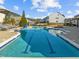 Large community pool with clear blue water, sun loungers, and a slide for residents at 3020 Mavisbank Cir, Apex, NC 27502