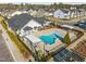 Aerial view of the community pool and clubhouse with surrounding residential neighborhood at 3020 Mavisbank Cir, Apex, NC 27502
