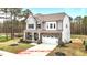 Beautiful two-story home boasts a stone facade and a well-manicured lawn in a tranquil neighborhood at 3020 Mavisbank Cir, Apex, NC 27502