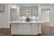 Gourmet kitchen island with white quartz countertops and modern grey cabinets at 3020 Mavisbank Cir, Apex, NC 27502