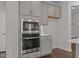 Modern stainless steel oven and microwave appliances with white quartz countertops at 3020 Mavisbank Cir, Apex, NC 27502