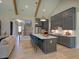 Open-concept kitchen with a waterfall island, breakfast bar, and stainless steel appliances at 303 Gilliland Rd, Siler City, NC 27344