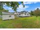 Backyard featuring lawn, house, outbuilding, and shade trees at 308 Charles St, Henderson, NC 27536