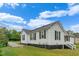 Charming exterior view of home showing siding, windows, and yard at 308 Charles St, Henderson, NC 27536