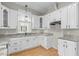 Spacious kitchen with white cabinets, granite countertops, and modern appliances at 308 Charles St, Henderson, NC 27536