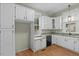 Kitchen with white cabinets, granite countertops, and a window over the sink at 308 Charles St, Henderson, NC 27536