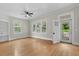Inviting living room with hardwood floors, large windows, ceiling fan, and a bright, airy ambiance at 308 Charles St, Henderson, NC 27536
