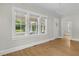 Bright living room featuring hardwood floors, large windows, and neutral paint tones at 308 Charles St, Henderson, NC 27536