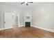 Open-concept living room with hardwood floors and decorative fireplace at 308 Charles St, Henderson, NC 27536