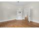 An open living space with fireplace and wood floors leading to another room at 308 Charles St, Henderson, NC 27536