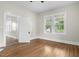 Bright living room with two windows and lovely wood floors throughout at 308 Charles St, Henderson, NC 27536