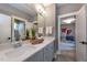 Modern bathroom with double sinks, vanity, mirror, and view into an adjacent bedroom at 315 Gilliland Rd, Siler City, NC 27344