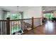 Hallway overlooking the staircase, complete with hardwood floors, shiplap walls, and natural lighting at 315 Gilliland Rd, Siler City, NC 27344