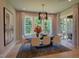 Elegant dining room featuring stylish lighting, large windows, and a view of the backyard at 321 Gilliland Rd, Siler City, NC 27344