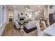 Open-concept living space with living room fireplace, modern kitchen, and hardwood floors at 367 Gilliland Rd, Siler City, NC 27344