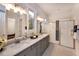 Bright main bathroom featuring double sinks, granite countertops, and a glass shower at 367 Gilliland Rd, Siler City, NC 27344