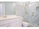 Bathroom featuring glass enclosed shower with rain head, and vanity with storage at 3700 Baron Cooper Pass # 104, Raleigh, NC 27612