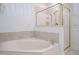 Relaxing bathroom with a soaking tub, a separate shower, and neutral tile at 3700 Baron Cooper Pass # 104, Raleigh, NC 27612