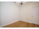 Bedroom showcasing hardwood floors, door and stylish chandelier at 3700 Baron Cooper Pass # 104, Raleigh, NC 27612