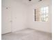 Bright bedroom with a large window, a door, and neutral walls and carpet at 3700 Baron Cooper Pass # 104, Raleigh, NC 27612