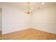 Spacious dining room with hardwood flooring and stylish chandelier at 3700 Baron Cooper Pass # 104, Raleigh, NC 27612