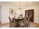 Formal dining room features a decorative chandelier, hardwood floors, and a china cabinet at 3700 Baron Cooper Pass # 104, Raleigh, NC 27612