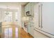 Stylish kitchen features robin's egg blue cabinets, stainless steel appliances, and an adjacent breakfast nook at 3700 Baron Cooper Pass # 104, Raleigh, NC 27612