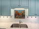 Close up of kitchen sink with decorative tile and marble countertop at 3700 Baron Cooper Pass # 104, Raleigh, NC 27612