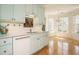 Charming kitchen boasting robin's egg blue cabinets, white countertops, and a chandelier-lit breakfast nook at 3700 Baron Cooper Pass # 104, Raleigh, NC 27612