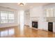 Living room with a fireplace, a window with natural light, hardwood floors, and a wet bar at 3700 Baron Cooper Pass # 104, Raleigh, NC 27612