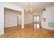 Open floor plan with chandelier lighting, columns and hard wood flooring at 3700 Baron Cooper Pass # 104, Raleigh, NC 27612