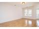 Spacious living room featuring wood floors, large window and access to a balcony at 3700 Baron Cooper Pass # 104, Raleigh, NC 27612