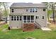 Back exterior view showcasing the home's architecture, screened porch, and outdoor space at 3729 Norman Blalock Rd, Willow Springs, NC 27592
