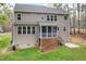 Back exterior view showcasing the home's architecture, screened porch, and outdoor space at 3729 Norman Blalock Rd, Willow Springs, NC 27592