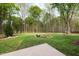 Expansive backyard featuring a fire pit and lush greenery, perfect for outdoor entertaining at 3729 Norman Blalock Rd, Willow Springs, NC 27592