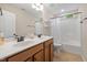 Bathroom with double vanity, white marble counters, and shower tub combo at 3729 Norman Blalock Rd, Willow Springs, NC 27592