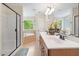 Bright bathroom features a glass shower, soaking tub, vanity with a granite countertop, and natural light at 3729 Norman Blalock Rd, Willow Springs, NC 27592