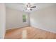 Empty bedroom featuring hardwood floors, a ceiling fan, and a window with natural light at 3729 Norman Blalock Rd, Willow Springs, NC 27592