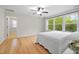 Bright bedroom features hardwood floors, a ceiling fan, and large windows with green views at 3729 Norman Blalock Rd, Willow Springs, NC 27592