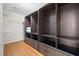 Custom closet with dark wood shelves and drawers, plus upper storage and wood floors at 3729 Norman Blalock Rd, Willow Springs, NC 27592