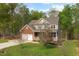 Beautiful two-story home featuring a well-manicured yard, two-car garage, charming porch and mature trees at 3729 Norman Blalock Rd, Willow Springs, NC 27592