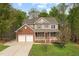 Gorgeous two-story home featuring a well-manicured yard, two-car garage, charming porch and mature trees at 3729 Norman Blalock Rd, Willow Springs, NC 27592