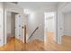 Upstairs hallway with hardwood floors and access to bedrooms at 3729 Norman Blalock Rd, Willow Springs, NC 27592