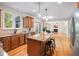 Open kitchen with granite island, stainless appliances, and wood floors flowing into the living room at 3729 Norman Blalock Rd, Willow Springs, NC 27592